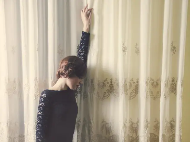 Michelle Dockery, visibly pregnant, flaunts her baby bump in a shimmering black dress while...